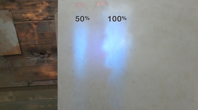 50% and 100% solution were sprayed on panel and shown with the black light