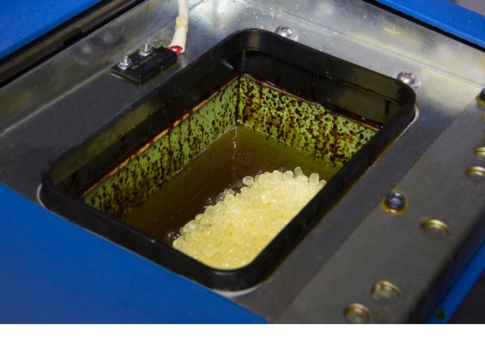 Hot melt adhesive built up in a hot melt system